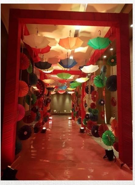 A corridor of coloured umbrellas and paper fans