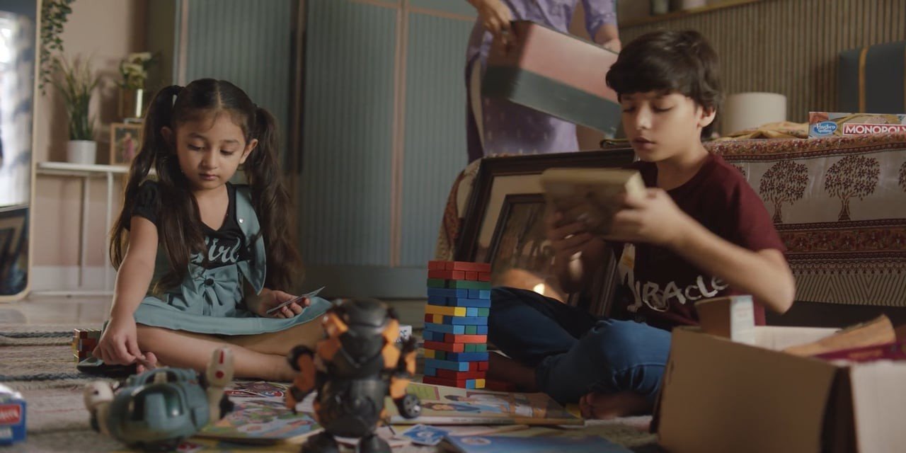 Two children unpacking boxes in the vmarc Diwali film